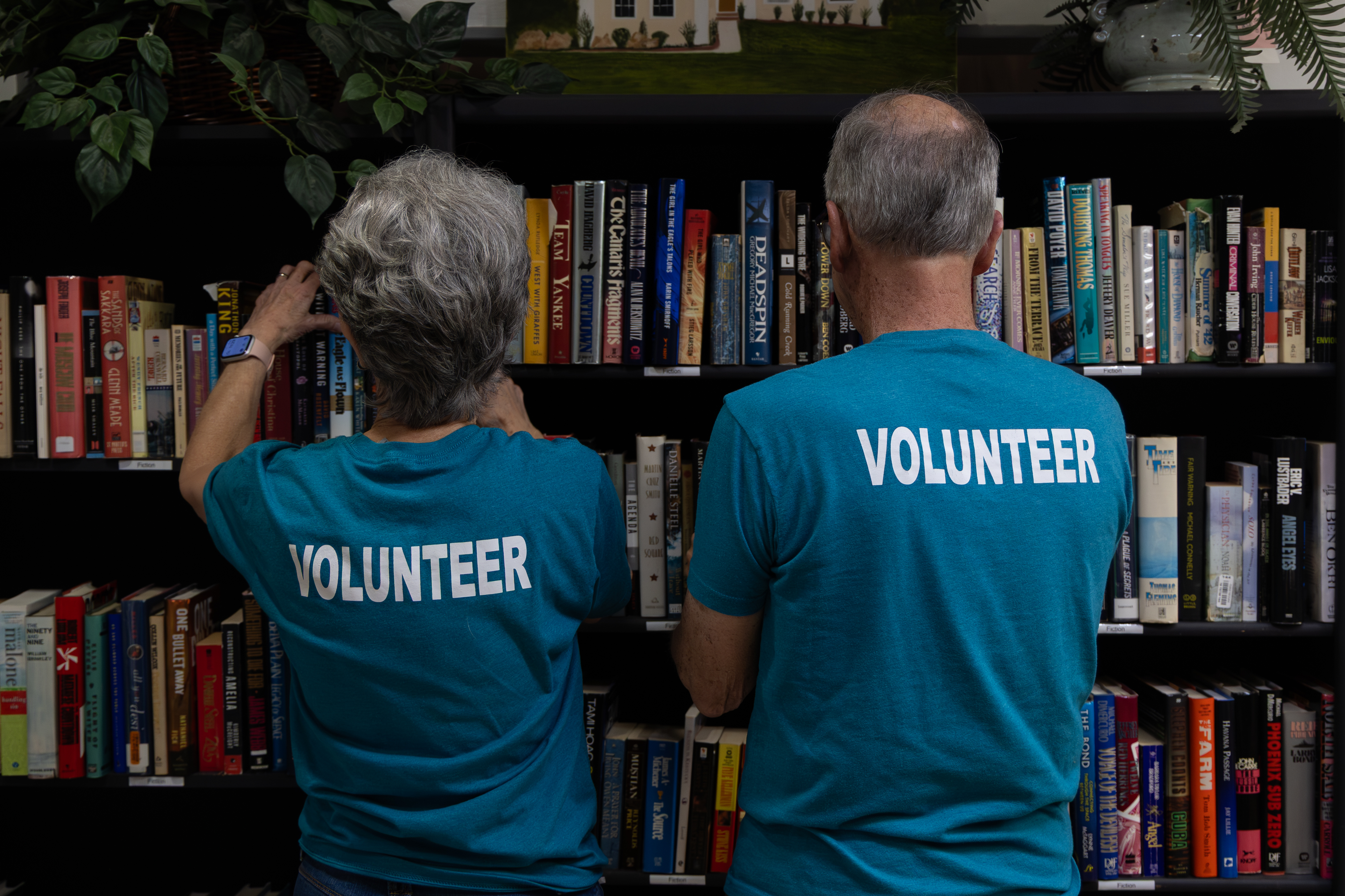 Core Volunteers Joe and Lillis organizing books in the ReStore