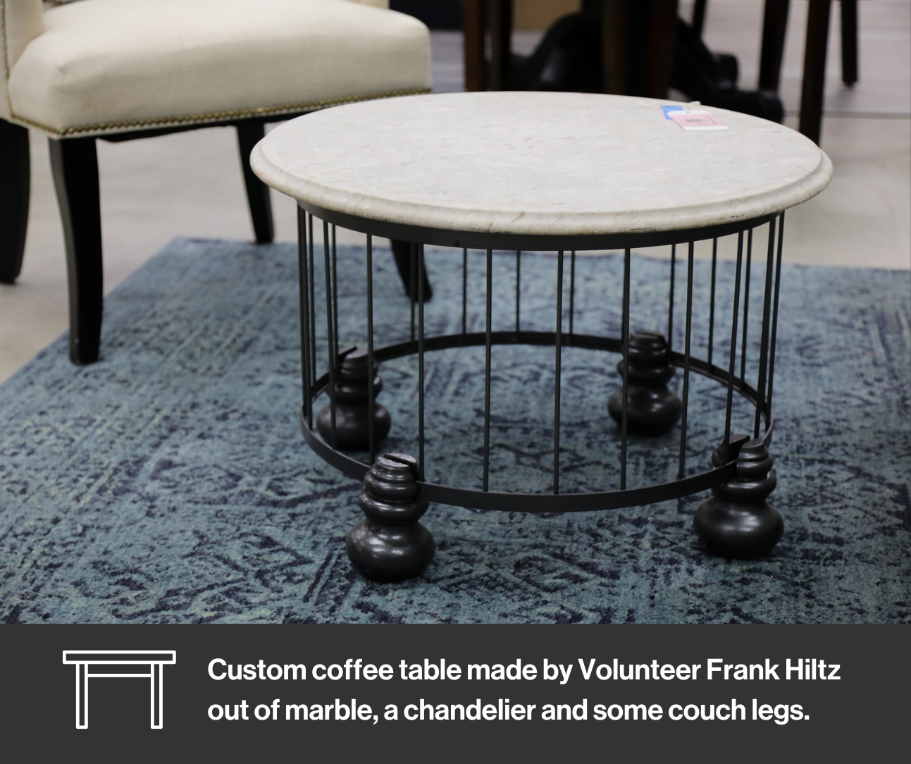 Custom coffee table made out of couch legs, a chandelier and a marble top.