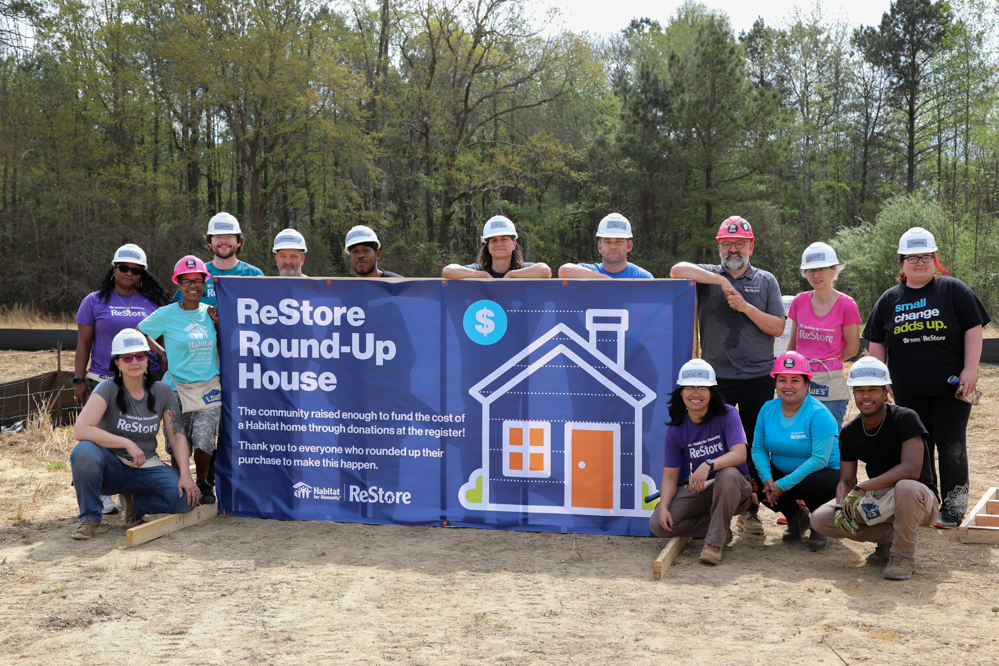 ReStore team posing on site of kickoff for the 2024 ReStore Round-Up House in Clayton, NC