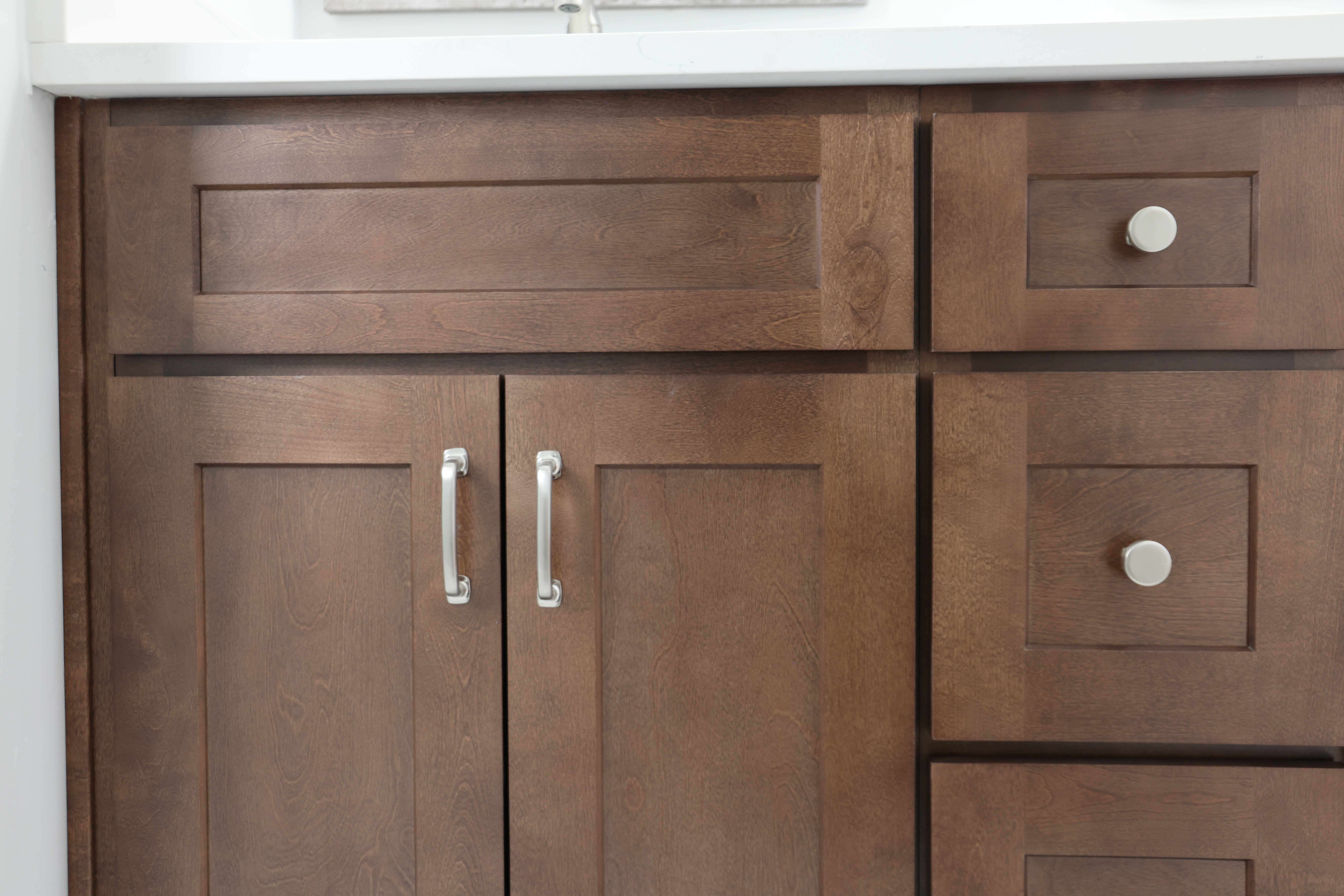 brown wood cabinets with knobs and pull hardware
