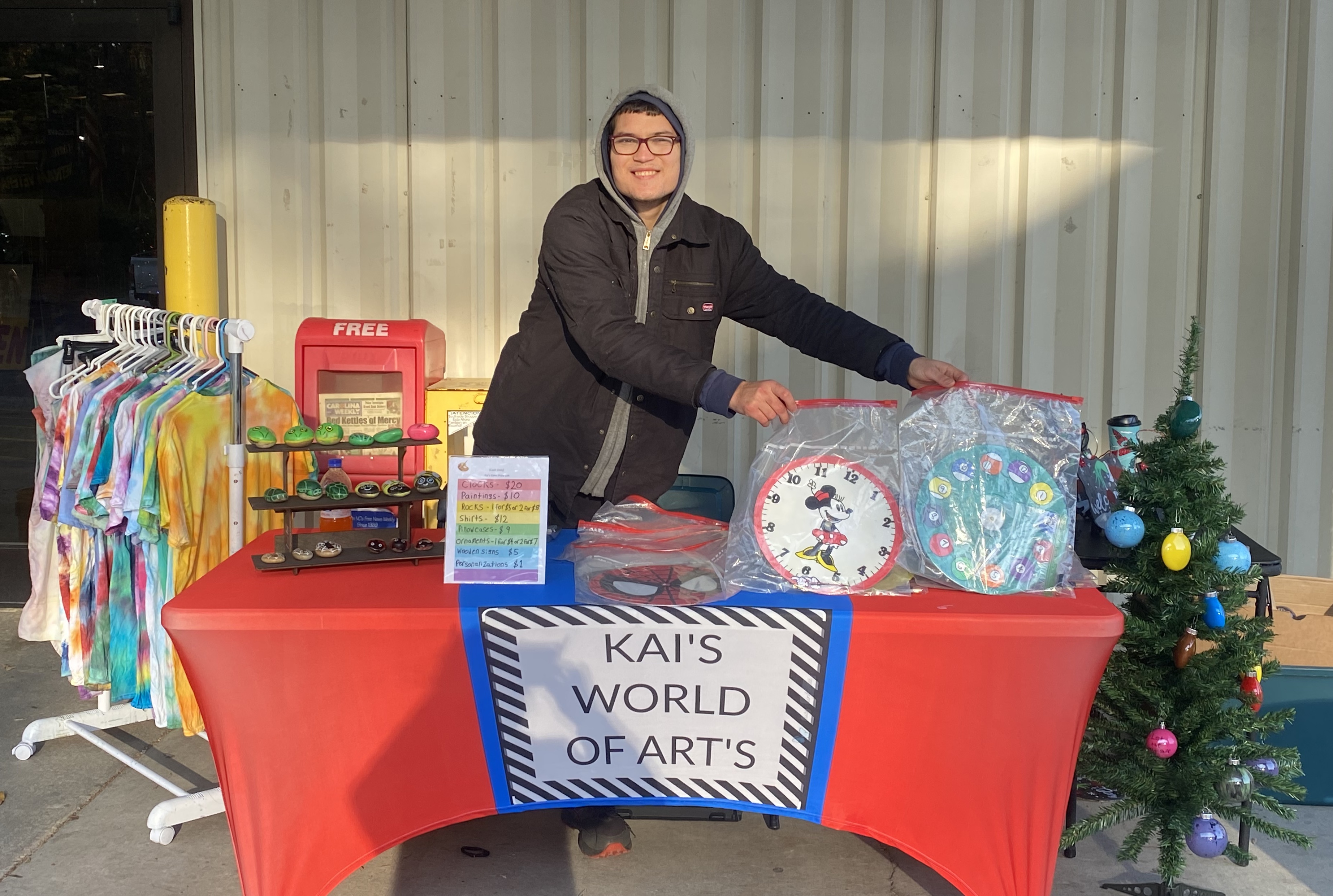photo of kai christopher with handmade crafts at flea market