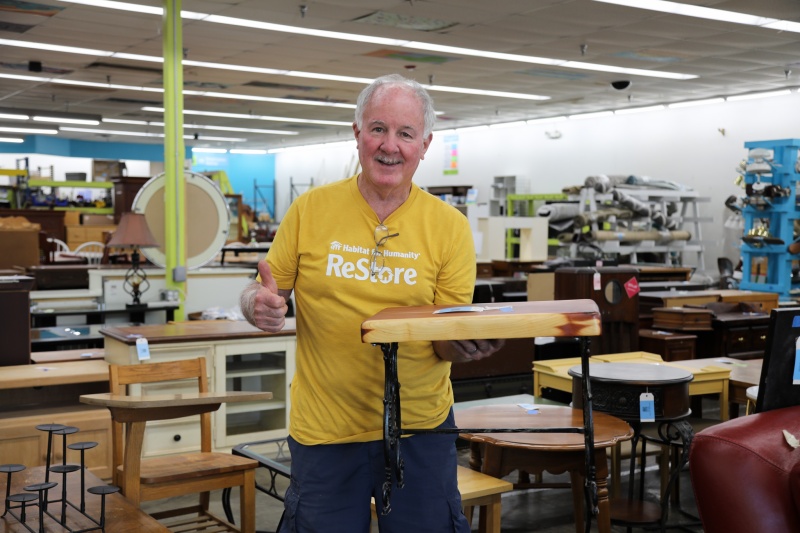 Core Volunteer Frank Hiltz holding custom table he made at the Cary ReStore