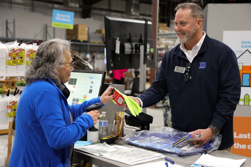 Staff checks out shopper at the register at Triangle ReStores